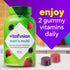 Vitafusion men's multi gummy vitamin bottle, berry flavors, with two red and purple gummies. Text: 'enjoy 2 gummy vitamins daily'.
