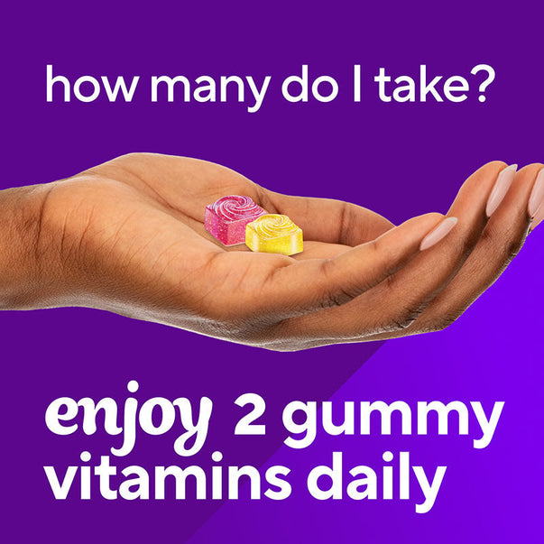 Two rose-shaped VF Prenatal Gummy vitamins are held in a hand, with the message 'enjoy 2 gummy vitamins daily'.