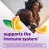 Happy couple embracing; graphic includes orange slices and text 'supports the immune system'.