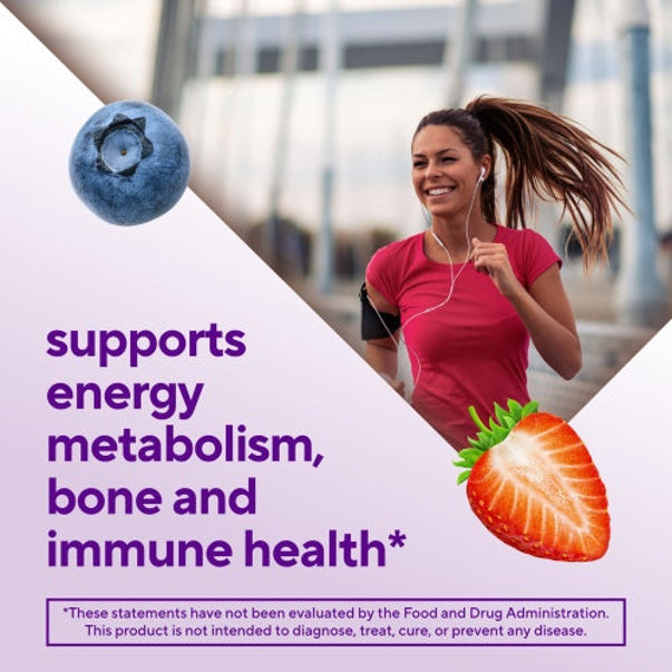 Young woman running outdoors, smiling, with a blueberry and strawberry for Women's Multi Gummy, supporting energy, bone, immune health.