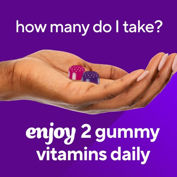 Hand holding pink and purple gummy vitamins with text: 'Take 2 gummy vitamins daily.'